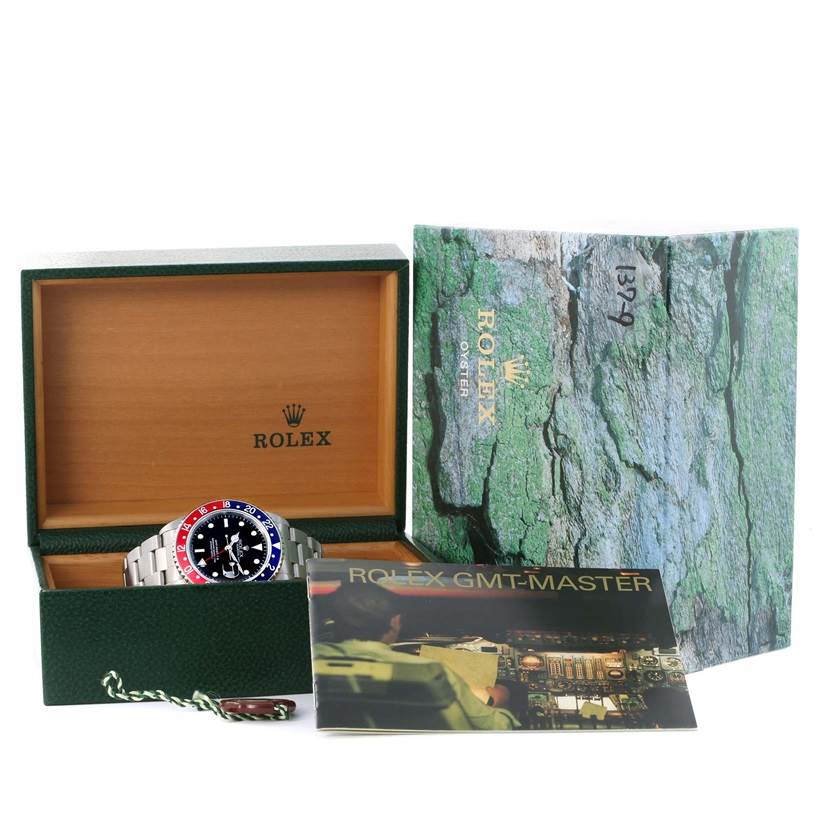The image shows a Rolex GMT-Master 16710 Men's Stainless Steel Black Dial 16710 Men's Stainless Steel Black Dial watch with its original packaging, manual, and accessories from a front angle.