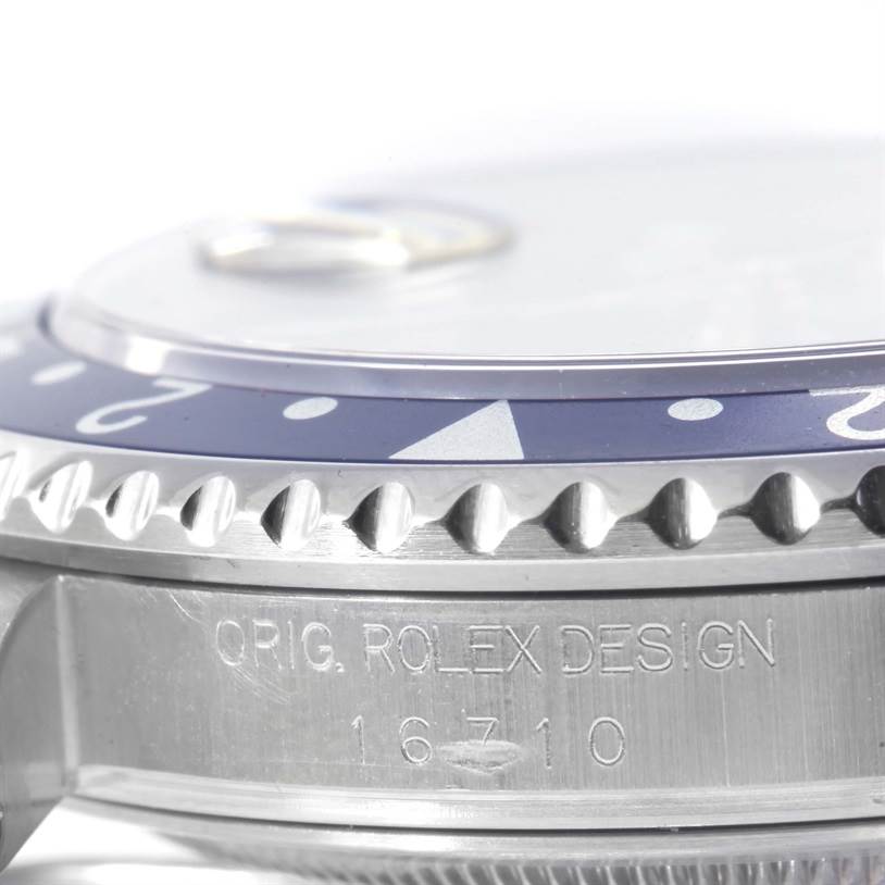 This image shows a close-up view of the bezel and side engraving of a Rolex GMT-Master 16710 Men's Stainless Steel Black Dial 16710 Men's Stainless Steel Black Dial model 16710 watch.