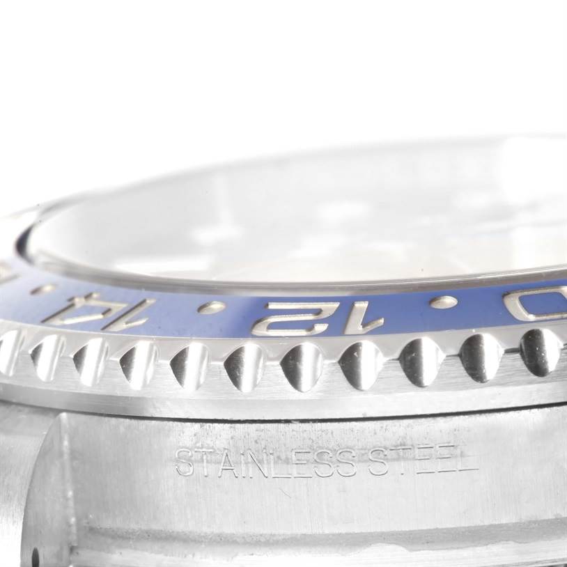 This close-up image of the Rolex GMT-Master 116710BLNR Men's Stainless Steel Black Dial 116710BLNR Men's Stainless Steel Black Dial watch shows the bezel and part of the stainless steel case.