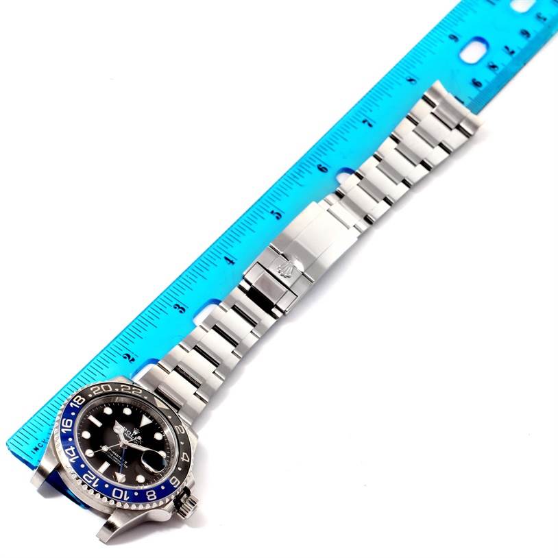 The image shows a Rolex GMT-Master 116710BLNR Men's Stainless Steel Black Dial 116710BLNR Men's Stainless Steel Black Dial watch laid flat with an emphasis on the bracelet, clasp, and part of the bezel near a ruler for measurement.