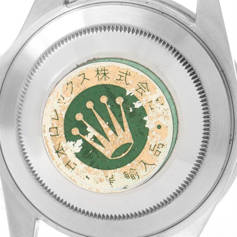 The image shows a close-up of the back case of a Rolex GMT-Master 16700 Men's Stainless Steel Black Dial 16700 Men's Stainless Steel Black Dial watch, featuring the Rolex crown logo and Japanese text.