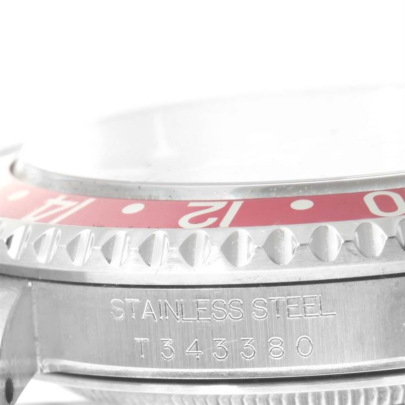 The image shows a close-up of the case, bezel, and part of the red dial of a Rolex GMT-Master 16700 Men's Stainless Steel Black Dial 16700 Men's Stainless Steel Black Dial watch.