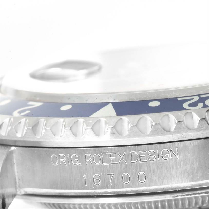 This close-up image of the Rolex GMT-Master 16700 Men's Stainless Steel Black Dial 16700 Men's Stainless Steel Black Dial watch shows the bezel and part of the case with model number 16700.