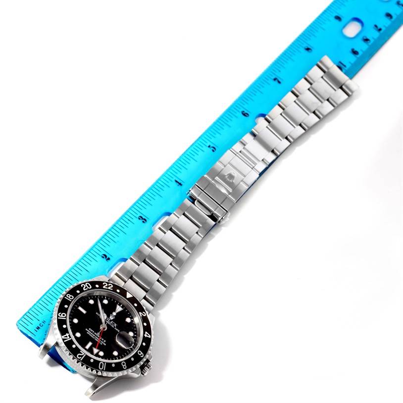 The image shows a Rolex GMT-Master 16710 Men's Stainless Steel Black Dial 16710 Men's Stainless Steel Black Dial watch laid flat with a blue ruler measuring its length.