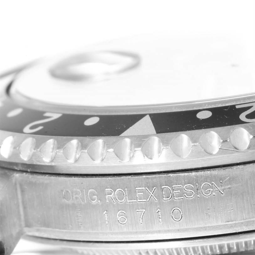 The image shows a close-up side view of the bezel and case engraving of a Rolex GMT-Master 16710 Men's Stainless Steel Black Dial 16710 Men's Stainless Steel Black Dial model.