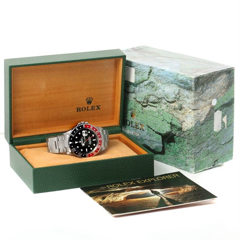 The Rolex GMT-Master 16710 Men's Stainless Steel Black Dial 16710 Men's Stainless Steel Black Dial watch is shown in an open box with its packaging and booklet visible.