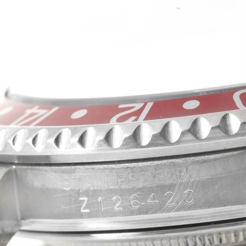 The image shows a close-up of the side view of the bezel and case with the serial number on the Rolex GMT-Master 16710 Men's Stainless Steel Black Dial 16710 Men's Stainless Steel Black Dial model.