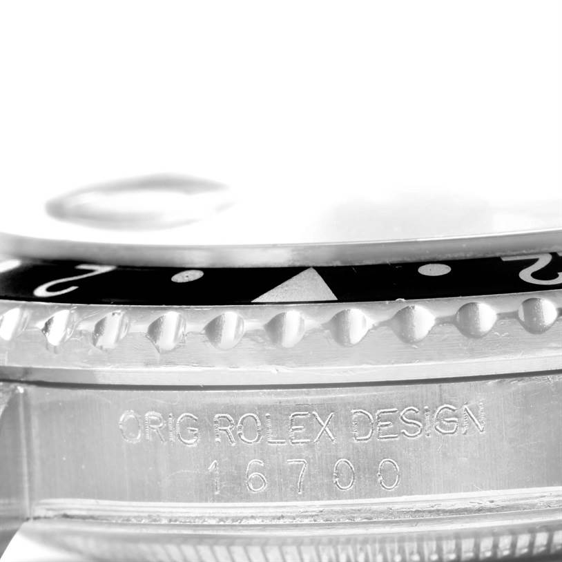 This image shows a close-up side view of the bezel and engraved case of a Rolex GMT-Master 16700 Men's Stainless Steel Black Dial 16700 Men's Stainless Steel Black Dial model 16700.