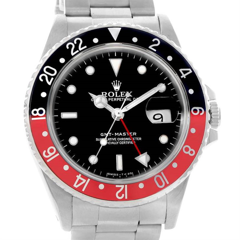 The Rolex GMT-Master watch is photographed from the front, showing its face, bezel, crown, and a portion of the bracelet.