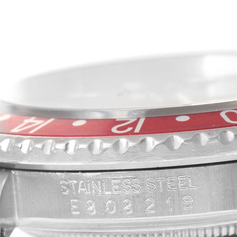 The image shows a close-up of the side and bezel of a Rolex GMT-Master 16700 Men's Stainless Steel Black Dial 16700 Men's Stainless Steel Black Dial, highlighting the stainless steel material and part of the serial number.
