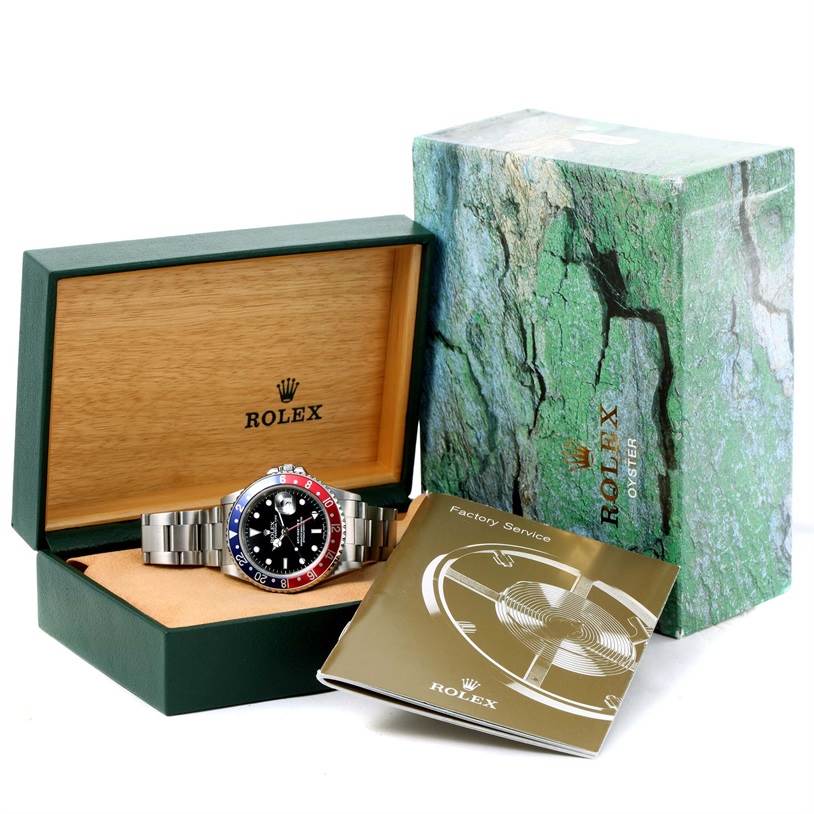 The image shows a Rolex GMT-Master 16710 Men's Stainless Steel Black Dial 16710 Men's Stainless Steel Black Dial watch in its open box, alongside the outer box and factory service booklet.