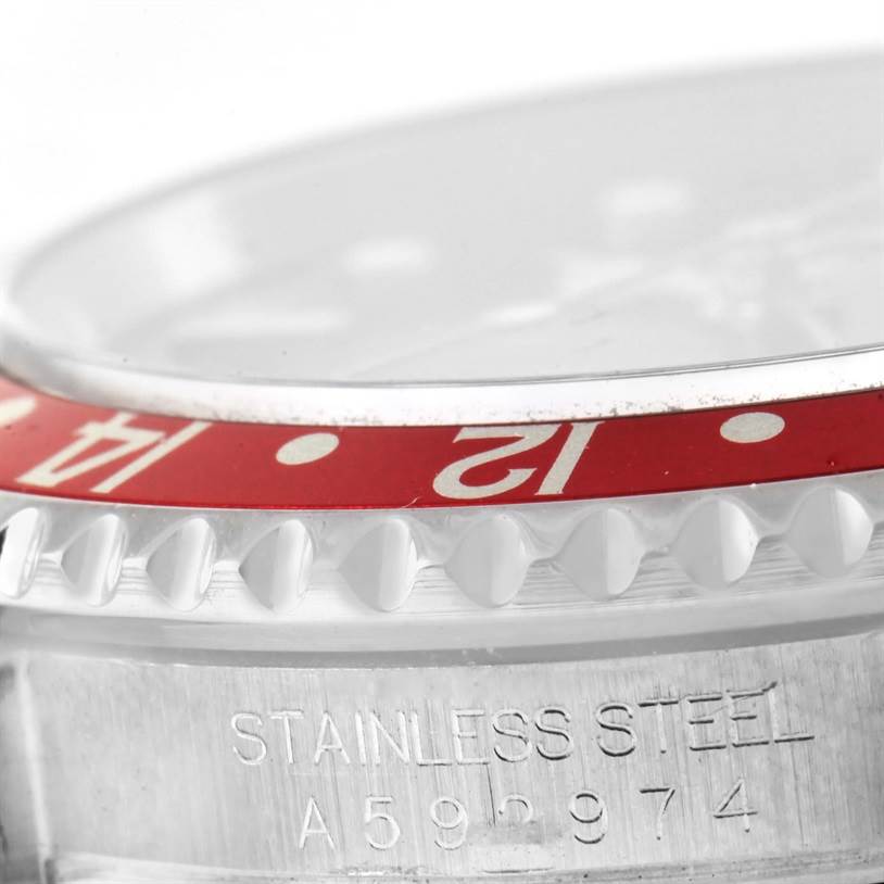 This image shows a close-up angle of the red bezel and stamped serial number on a Rolex GMT-Master 16710 Men's Stainless Steel Black Dial 16710 Men's Stainless Steel Black Dial watch in stainless steel.