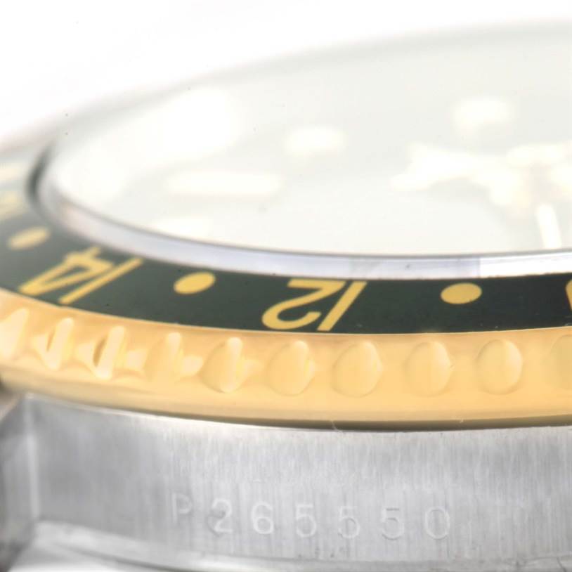 The image shows a close-up side angle of the bezel, crystal, and part of the case of a Rolex GMT-Master 16713 Men's Stainless Steel Black Dial 16713 Men's Stainless Steel Black Dial watch, highlighting the serial number.
