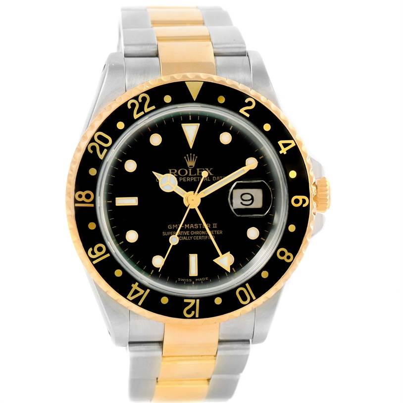 The image shows a front view of a Rolex GMT-Master 16713 Men's Stainless Steel Black Dial 16713 Men's Stainless Steel Black Dial II watch, highlighting its black dial, gold bezel, and two-tone bracelet.