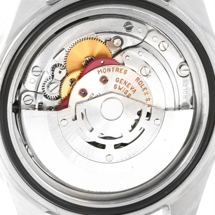 The image shows the internal mechanism of a Rolex GMT-Master 16713 Men's Stainless Steel Black Dial 16713 Men's Stainless Steel Black Dial watch from a rear angle, revealing gears and the rotor.