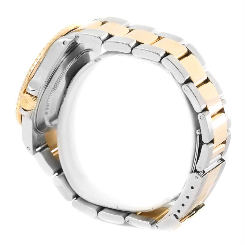 Side view of a Rolex GMT-Master 16713 Men's Stainless Steel Black Dial 16713 Men's Stainless Steel Black Dial watch, showcasing the two-tone bracelet and crown.