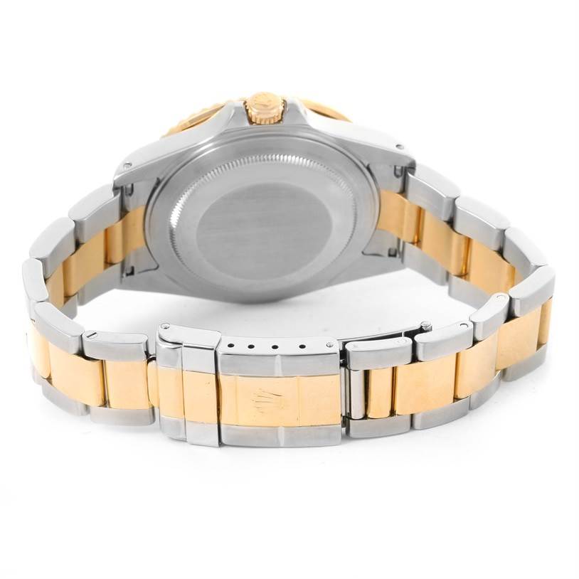 The image shows the underside and bracelet of a Rolex GMT-Master 16713 Men's Stainless Steel Black Dial 16713 Men's Stainless Steel Black Dial watch, highlighting its two-tone metal design.