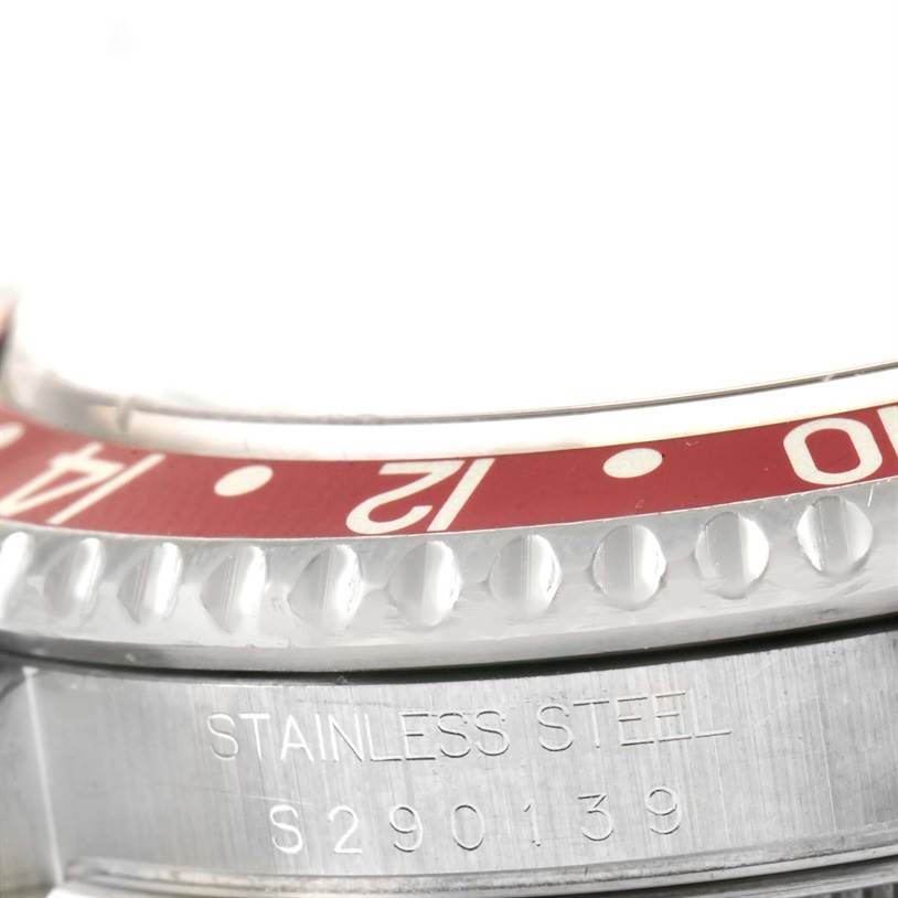 This close-up image of the Rolex GMT-Master 16710 Men's Stainless Steel Black Dial 16710 Men's Stainless Steel Black Dial shows a section of the bezel and the "STAINLESS STEEL" engraving with a serial number.