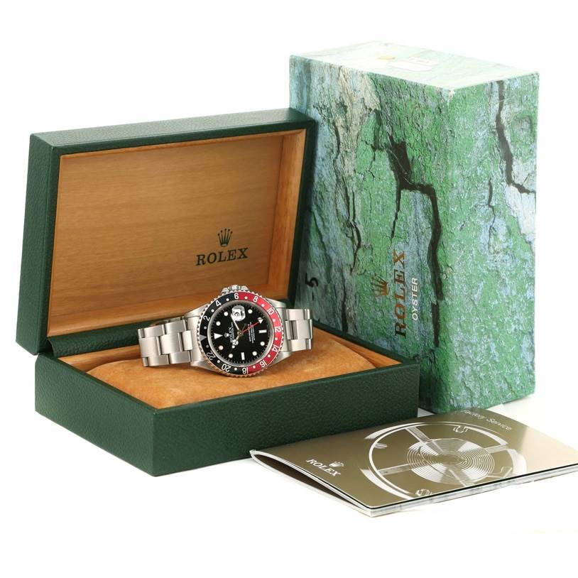 The image shows a Rolex GMT-Master 16710 Men's Stainless Steel Black Dial 16710 Men's Stainless Steel Black Dial watch, with its box, manual, and outer box, all viewed from an angled perspective.
