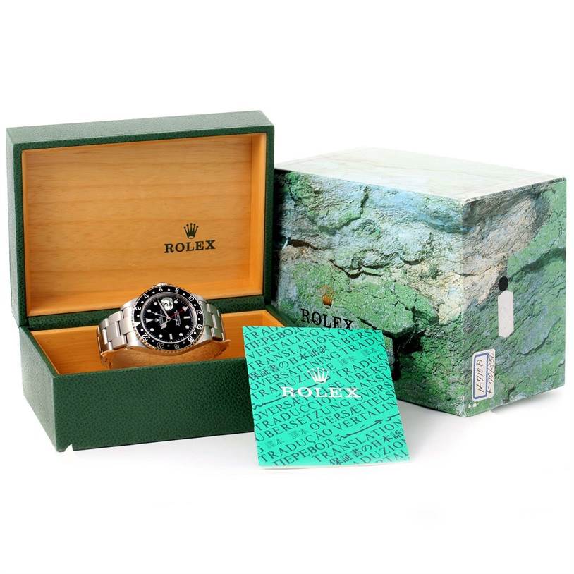 The Rolex GMT-Master 16710 Men's Stainless Steel Black Dial 16710 Men's Stainless Steel Black Dial watch is shown from a front angle in its open display box with accompanying accessories and outer box.