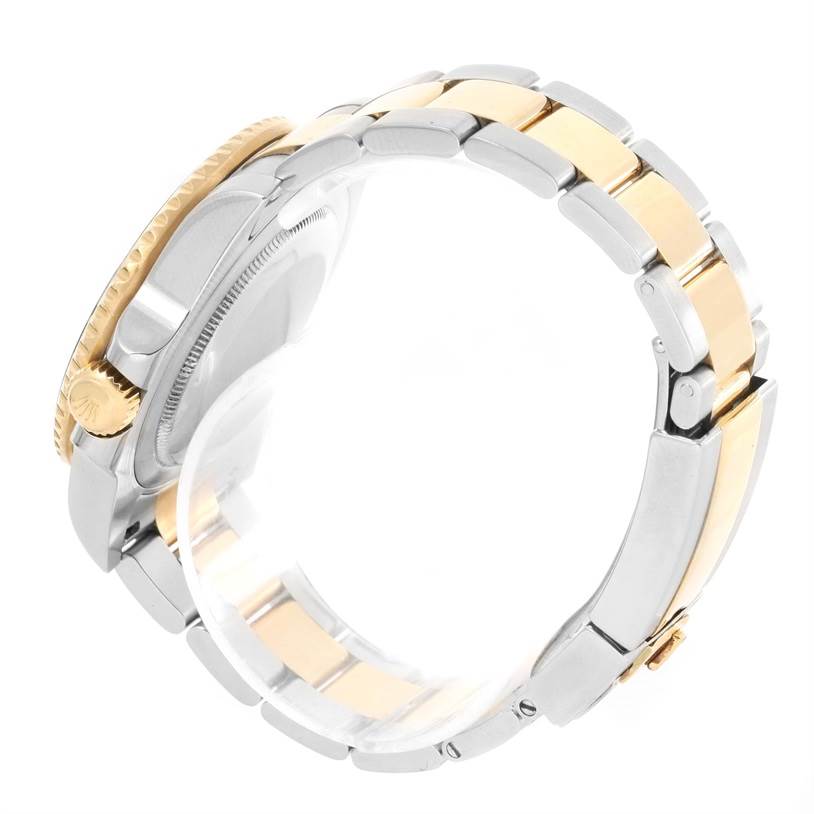 The Rolex GMT-Master 116713 Men
s Stainless Steel Black Dial 116713 Men
s Stainless Steel Black Dial is shown from the side, highlighting its gold and silver bracelet and crown.