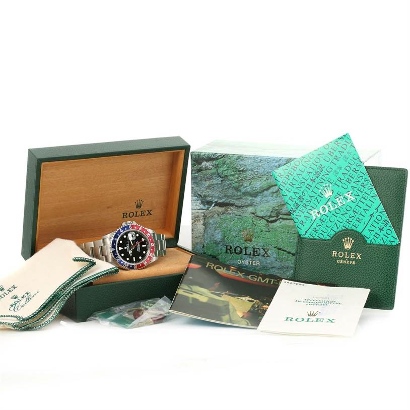 The image shows a Rolex GMT-Master 16700 Men's Stainless Steel Black Dial 16700 Men's Stainless Steel Black Dial watch in its box, accompanied by various accessories and booklets from a frontal angle.