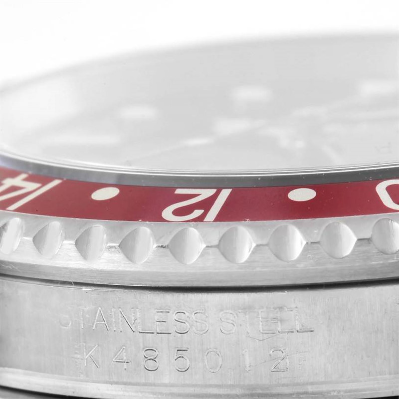 The image shows a close-up side angle of the bezel and case with engravings of the Rolex GMT-Master watch.