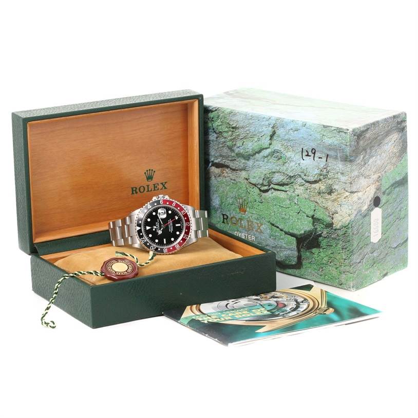 The image shows a Rolex GMT-Master 16710 Men's Stainless Steel Black Dial 16710 Men's Stainless Steel Black Dial watch in its open box with accompanying accessories and manuals.