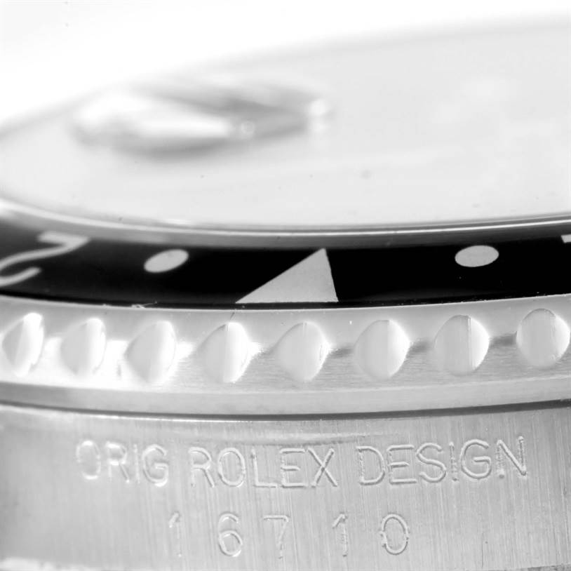 The image shows a close-up angle of the bezel and case of the Rolex GMT-Master 16710 Men's Stainless Steel Black Dial 16710 Men's Stainless Steel Black Dial with the model number 16710 visible.