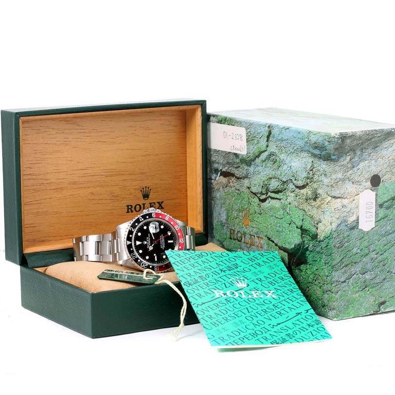 The image shows a Rolex GMT-Master 16710 Men's Stainless Steel Black Dial 16710 Men's Stainless Steel Black Dial watch inside its open box, along with the outer box and accompanying paperwork.