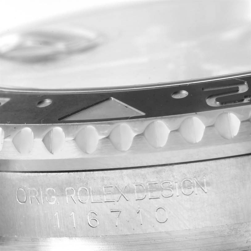 This close-up angle of the Rolex GMT-Master 116710 Men's Stainless Steel Black Dial 116710 Men's Stainless Steel Black Dial shows the bezel edge with the marker and the engraved model number (116710) on the case.