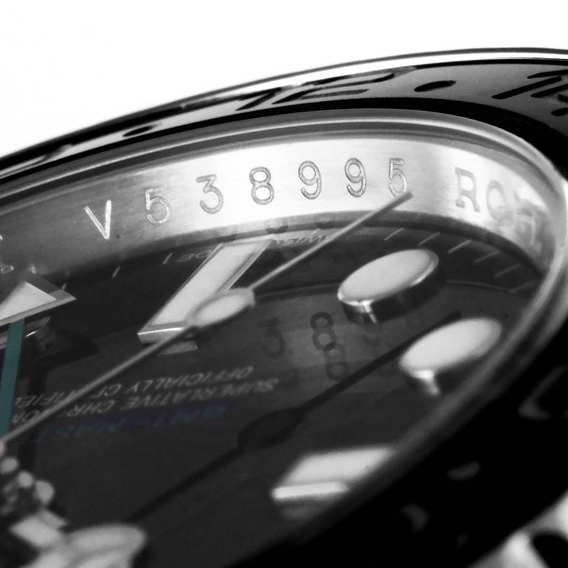 This image shows a close-up angled view of the Rolex GMT-Master 116710BKSO Men's Stainless Steel Black Dial 116710BKSO Men's Stainless Steel Black Dial watch, highlighting the serial number and part of the dial and bezel.