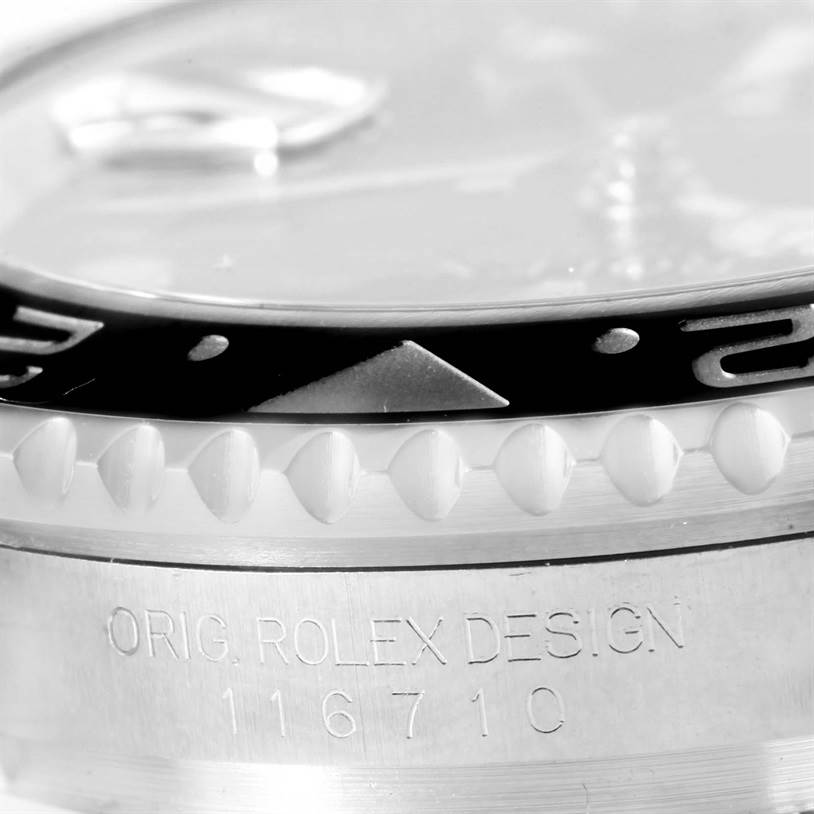 This close-up image of the Rolex GMT-Master 116710BKSO Men's Stainless Steel Black Dial 116710BKSO Men's Stainless Steel Black Dial watch shows the bezel, the engraved markings, and part of the case.