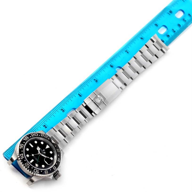 The image shows a Rolex GMT-Master 116710BKSO Men's Stainless Steel Black Dial 116710BKSO Men's Stainless Steel Black Dial watch laid flat, with a ruler measuring its bracelet.