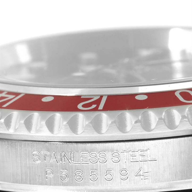 This close-up image shows the bezel and a portion of the case of the Rolex GMT-Master 16710 Men's Stainless Steel Black Dial 16710 Men's Stainless Steel Black Dial watch in stainless steel.