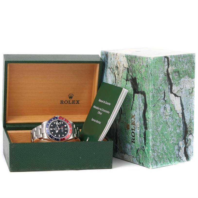 The image shows a Rolex GMT-Master 16710 Men's Stainless Steel Black Dial 16710 Men's Stainless Steel Black Dial watch inside an open green Rolex box, with booklets placed next to it.