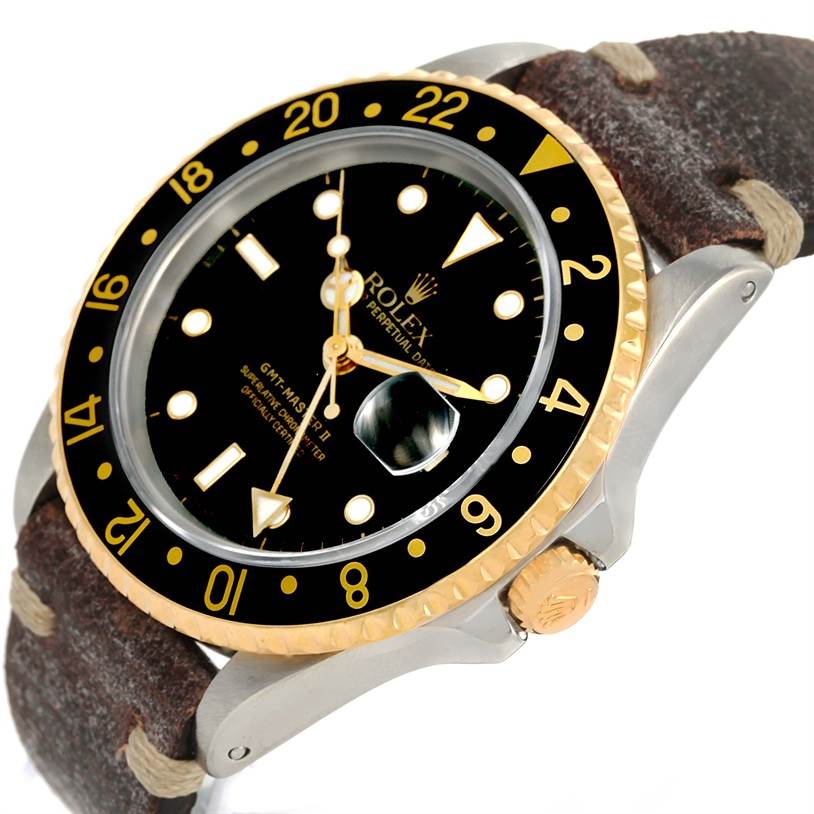 This image shows a Rolex GMT-Master 16713 Men's Stainless Steel Black Dial 16713 Men's Stainless Steel Black Dial watch at an angle highlighting its face, bezel, crown, and leather strap.