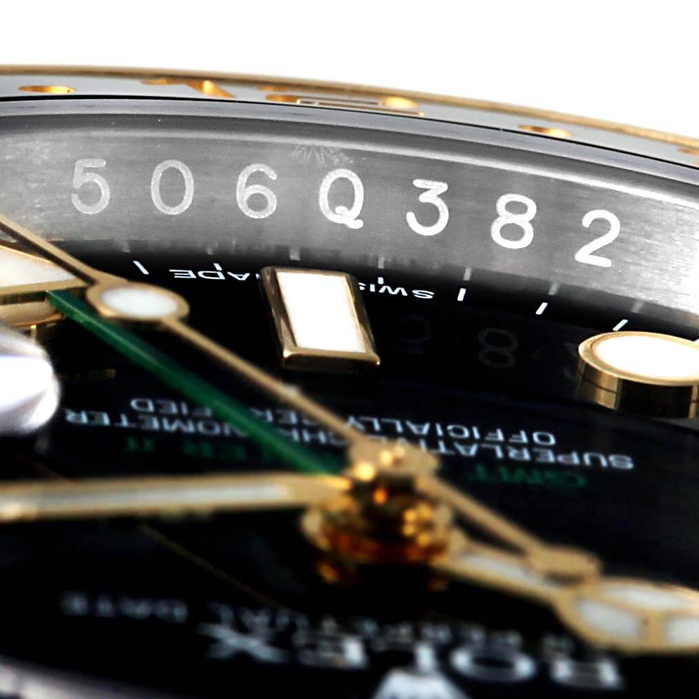 The image shows a zoomed-in view of the Rolex GMT-Master 116713 Men's Stainless Steel Black Dial 116713 Men's Stainless Steel Black Dial dial, displaying the hour markers, hands, and partial serial number.