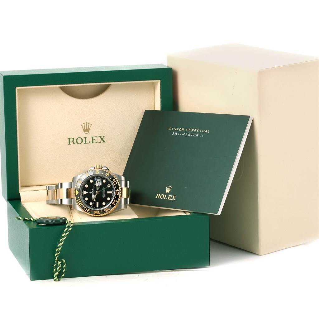 The Rolex GMT-Master 116713 Men's Stainless Steel Black Dial 116713 Men's Stainless Steel Black Dial watch is displayed in its open box, with accompanying manual and accessories.