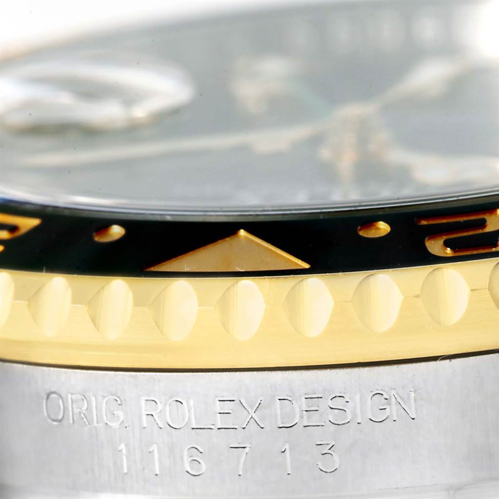 The image shows a close-up of the bezel and part of the side case of a Rolex GMT-Master 116713 Men's Stainless Steel Black Dial 116713 Men's Stainless Steel Black Dial, highlighting the "ORIG ROLEX DESIGN" engraving and model number.