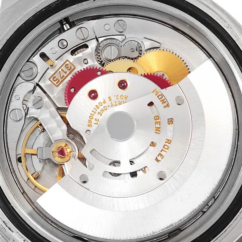 The image shows a close-up of the movement mechanism inside a Rolex GMT-Master 16700 Men's Stainless Steel Black Dial 16700 Men's Stainless Steel Black Dial model watch, highlighting gears and the rotor.