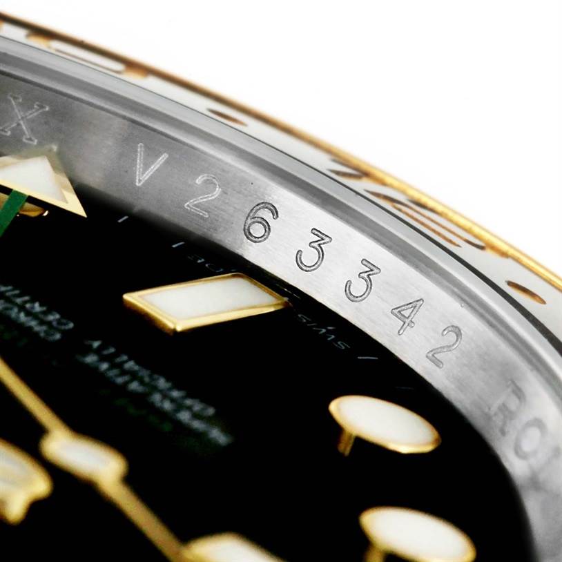The image shows a close-up of the watch face and bezel engraving of the Rolex GMT-Master 116713 Men's Stainless Steel Black Dial 116713 Men's Stainless Steel Black Dial, highlighting the serial number.
