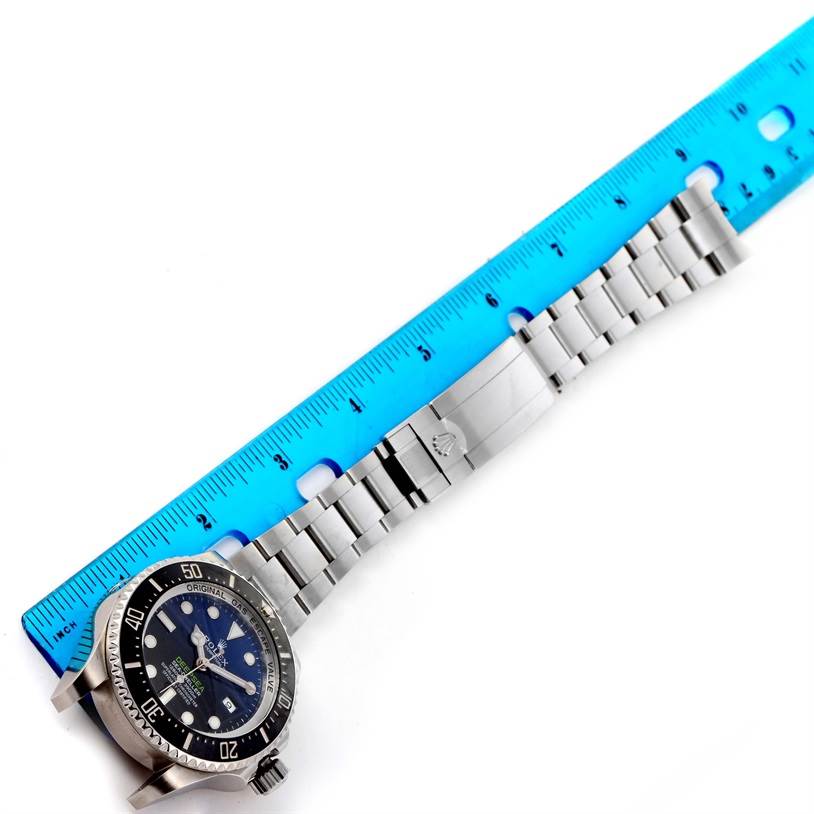 This Rolex GMT-Master 116660 Men's Stainless Steel Blue Dial 116660 Men's Stainless Steel Blue Dial watch is shown flat with a blue ruler measuring its stainless steel bracelet and clasp.
