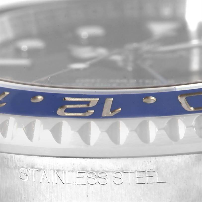 The image shows a close-up of the bezel, crystal, and part of the case of a Rolex GMT-Master 116710 Men's Stainless Steel Black Dial 116710 Men's Stainless Steel Black Dial watch.