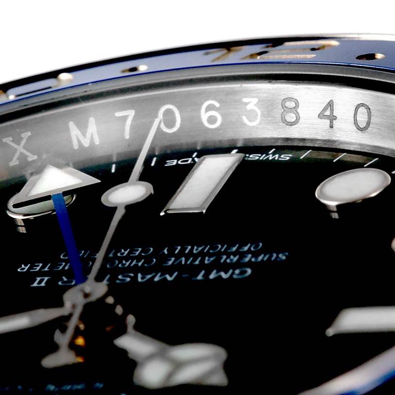 Close-up of the dial and serial number of a Rolex GMT-Master 116710 Men's Stainless Steel Black Dial 116710 Men's Stainless Steel Black Dial watch, showing the hands and part of the bezel.