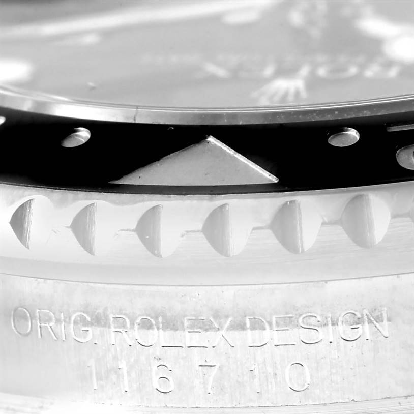 This close-up image of the Rolex GMT-Master 116710 Men
s Stainless Steel Black Dial 116710 Men
s Stainless Steel Black Dial watch shows the bezel, case, and part of the engraved design and model number.