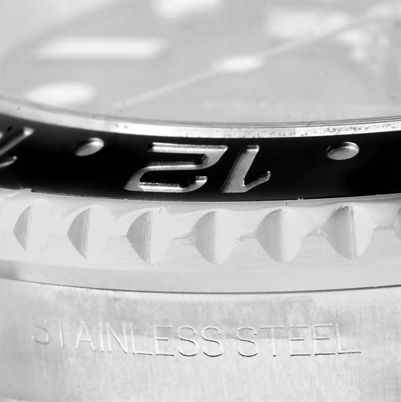 This close-up image shows the bezel and part of the case with "STAINLESS STEEL" engraving of the Rolex GMT-Master 116710 Men
s Stainless Steel Black Dial 116710 Men
s Stainless Steel Black Dial watch.