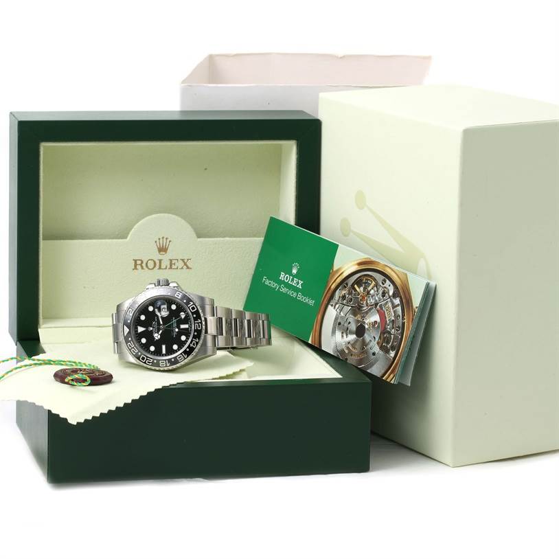 The image shows a Rolex GMT-Master 116710 Men
s Stainless Steel Black Dial 116710 Men
s Stainless Steel Black Dial watch in its original box, with a factory service booklet and tags included.