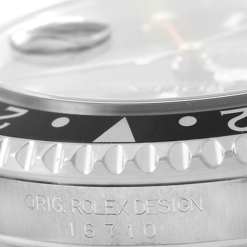 The image shows a close-up side view of the bezel and engraved case of a Rolex GMT-Master 16710 Men's Stainless Steel Black Dial 16710 Men's Stainless Steel Black Dial watch.