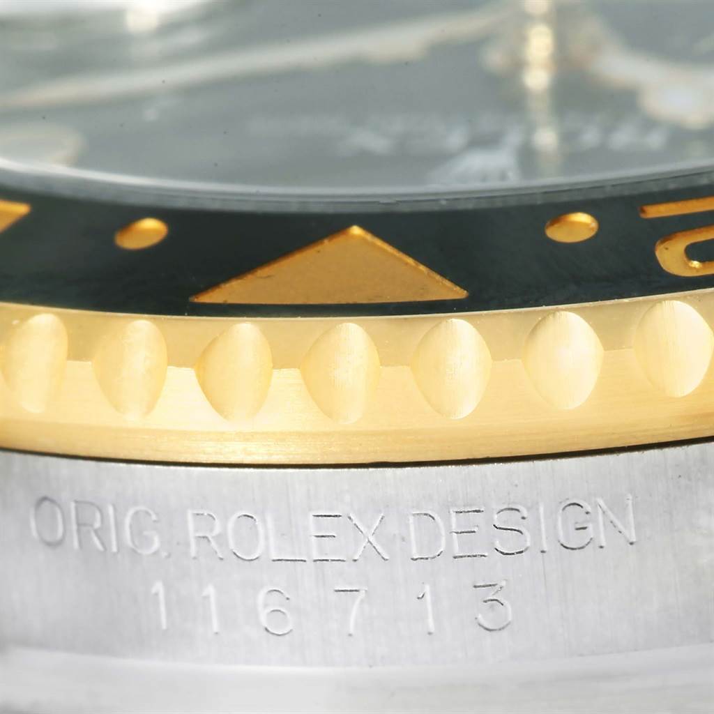 The image shows a close-up of the bezel and case side of a Rolex GMT-Master 116713 Men's Stainless Steel Black Dial 116713 Men's Stainless Steel Black Dial watch, including the model number and "ORIG. ROLEX DESIGN" engraving.